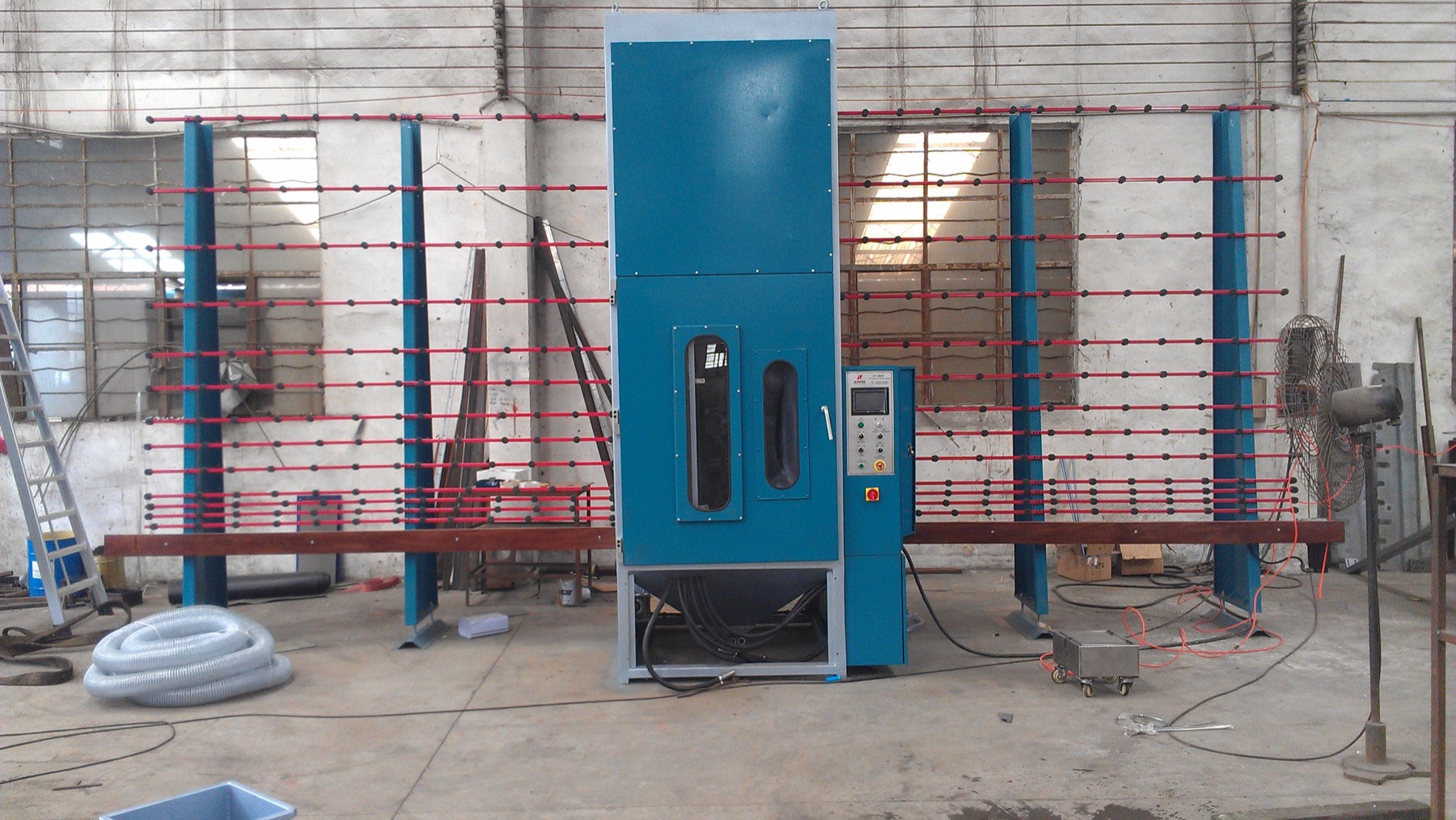 Full view of a vertical glass sandblasting machine and dust collection unit