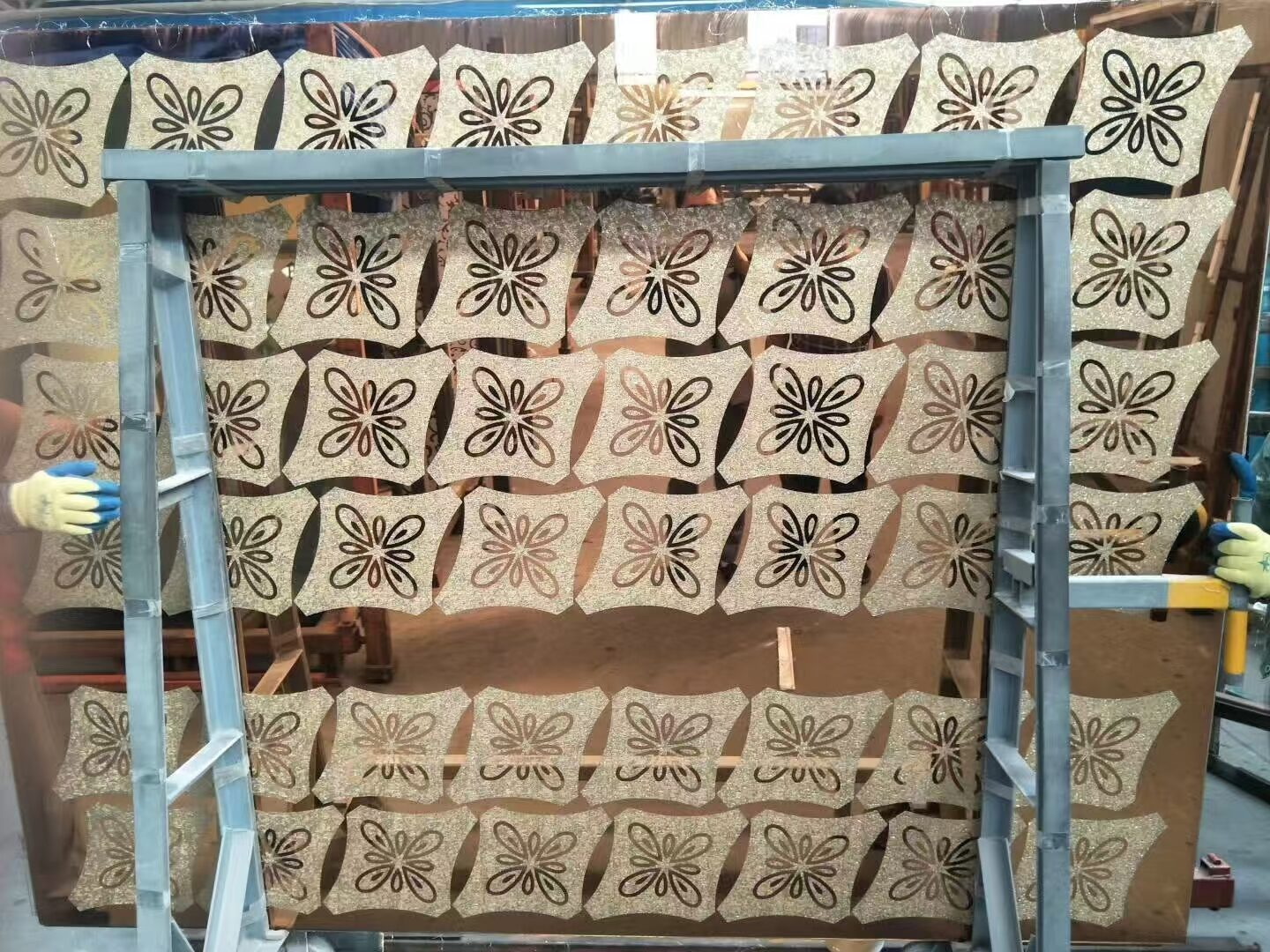 Rack of patterned sandblasted glass panels in production