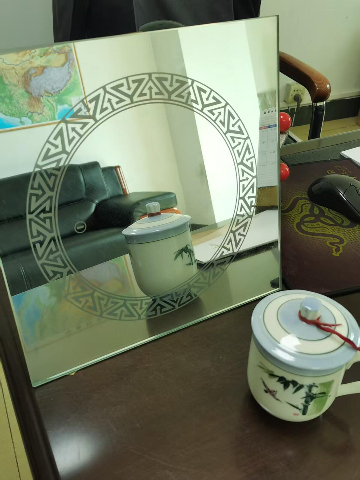 Mirror with a sandblasted etched border pattern